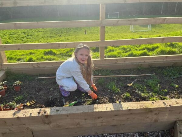 A Pupil Working On The Garden